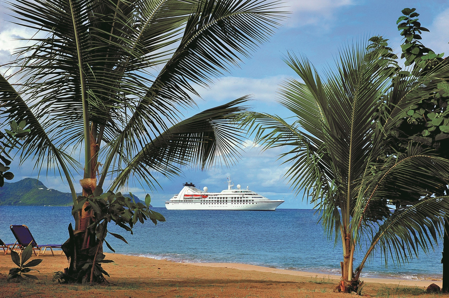 Exterior view of Star Pride beyond palm trees in Mayreau